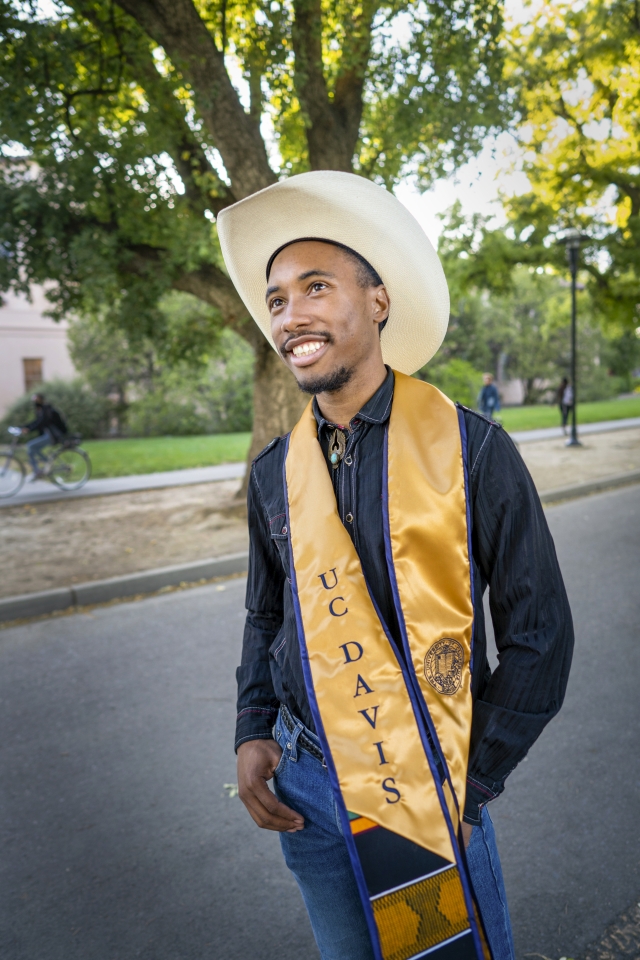 Nate Walker smiling in his graduation clothes. 