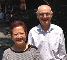 Ester and Michael Vaida pose outdoors on campus while smiling.